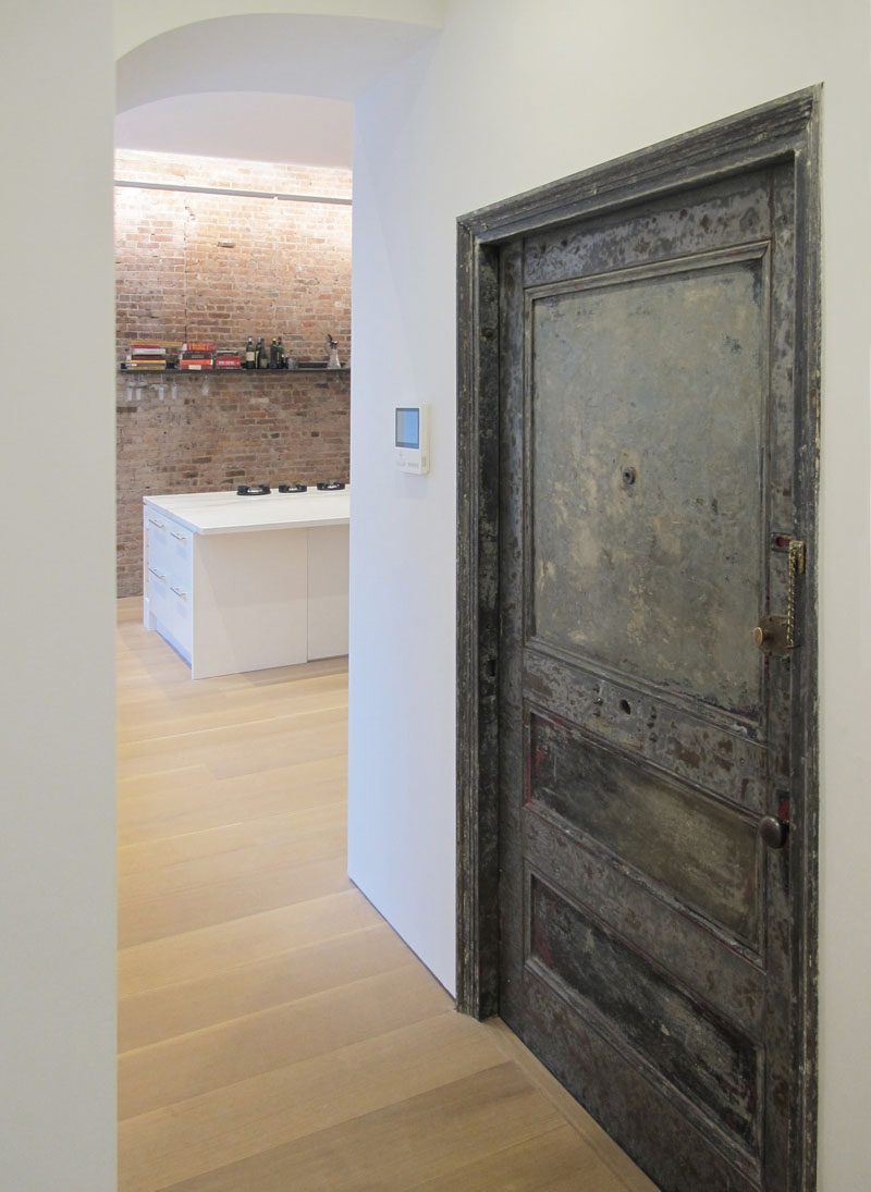 An old existing metal door to the stairs was cleaned and re-used, showing a glimpse of the past. #MetalDoor #DoorIdeas