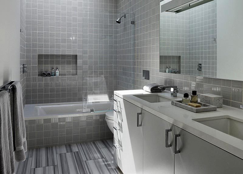 This modern grey bathroom features a shower niche that can be accessed from the shower and the bath. #ShowerNicheIdeas #ShowerNiche #ModernBathroom #BathroomDesign #BathroomIdeas
