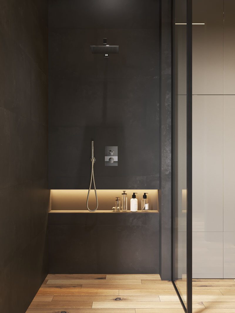 This modern bathroom has a horizontal shower niche with hidden lighting for storage. #ModernBathroom #ShowerNiche #ShowerNicheIdeas #BathroomStorage