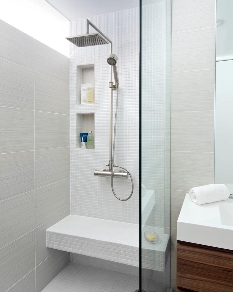 This modern bathroom has two shower niches to allow people at different heights to easily access them. #ShowerNicheIdeas #ModernShowerNiches #ShowerNiche #MultipleShowerNiches