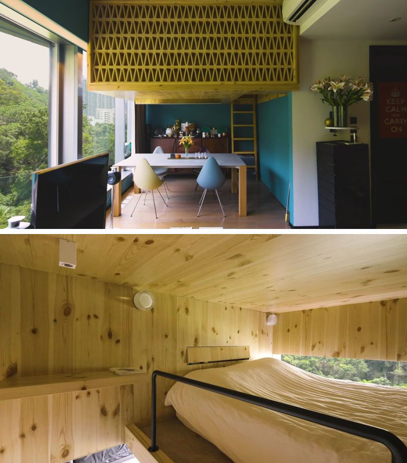 A box-loft sleeping area above the dining room in this small apartment, is clad in natural pine and seems to float like a tree house, with a window that provides views of the forest outside. #LoftedBedroom #BedroomLoft #SmallApartment #InteriorDesign