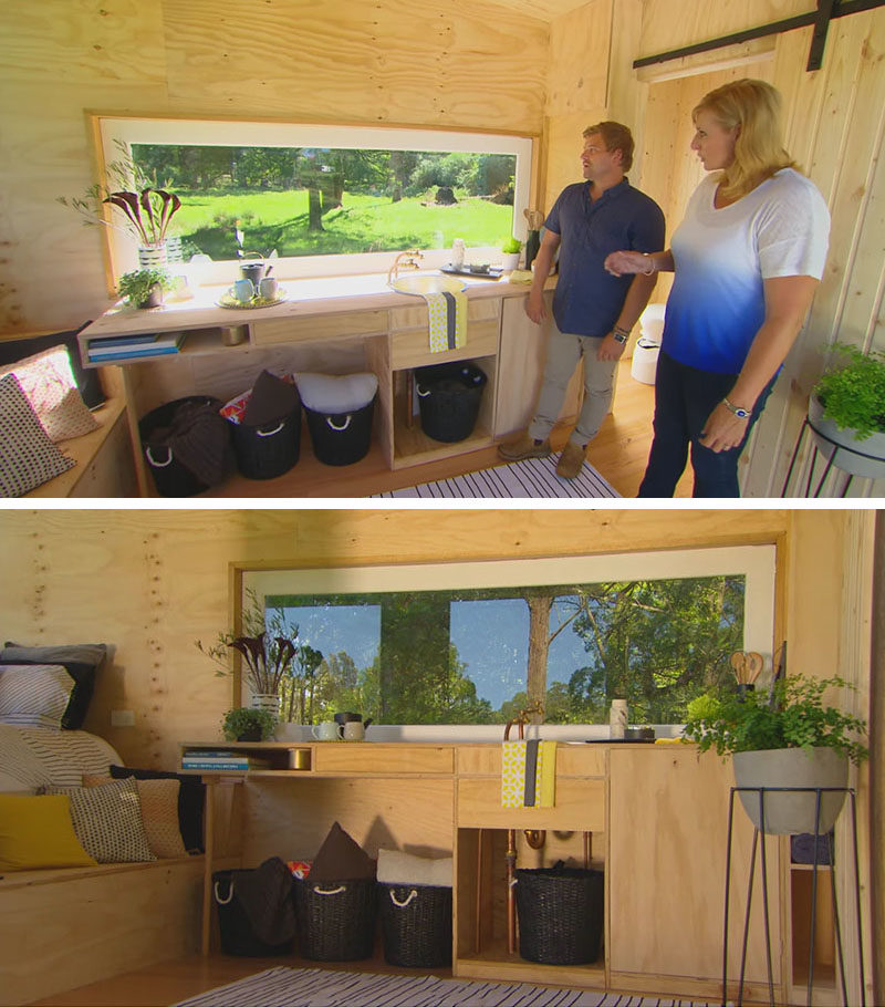 Tiny House Ideas - This tiny kitchen made from plywood has a window that also doubles as a backsplash. #TinyHouseIdeas #TinyHouseKitchen #SmallHouse #WindowBacksplash