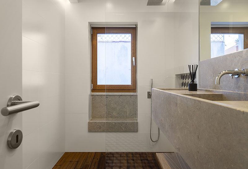 Bathroom Ideas - The shower in this modern bathroom has a built-in window seat (or bench), that makes use of a small alcove. #BathroomIdeas #ShowerSeat #ShowerBench #WindowSeat #WindowBench #ModernBathroom