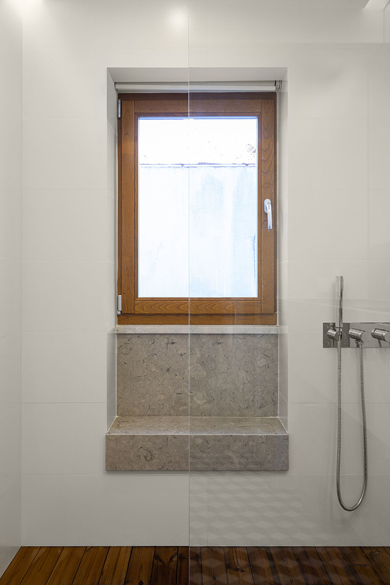 Bathroom Ideas - The shower in this modern bathroom has a built-in window seat (or bench), that makes use of a small alcove. #BathroomIdeas #ShowerSeat #ShowerBench #WindowSeat #WindowBench #ModernBathroom