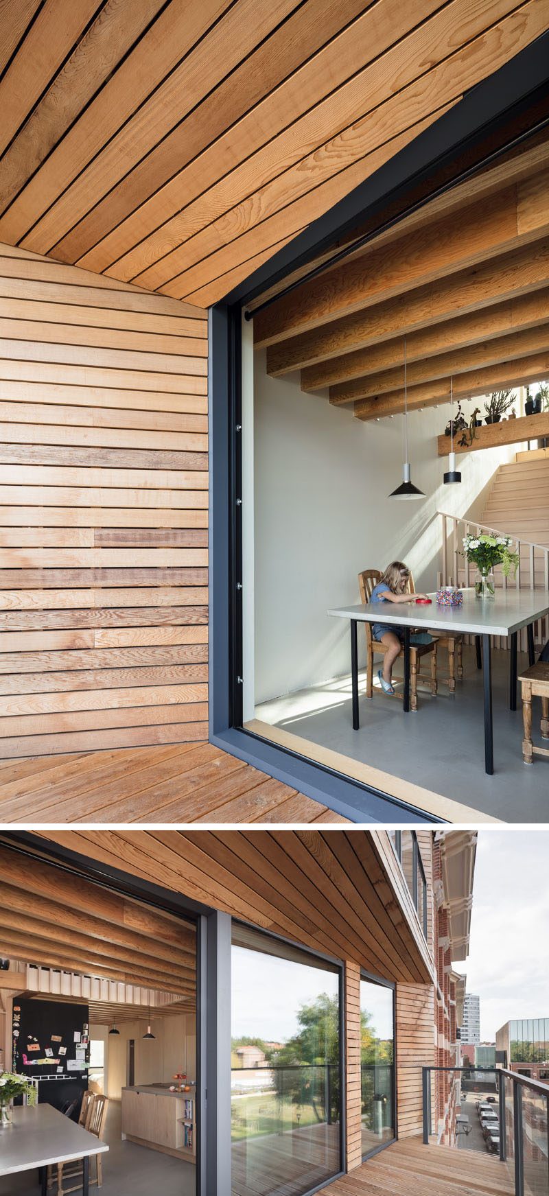 The dining area and kitchen of this modern house open up to the partially covered balcony that overlooks the city. #Balcony #ModernBalcony #WoodLinedBalcony