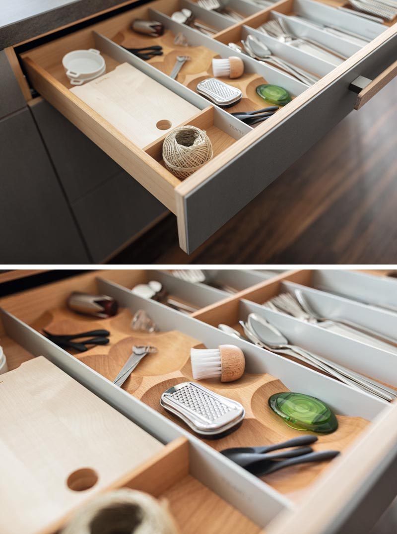 Kitchen Organization Ideas - This modern and modular drawer design combines removable trays, inserts, dividers, knife blocks, spice jars, and foil rolls that can be configured individually. A special solid-wood chopping board can also be integrated into the  drawer fittings. #KitchenOrganization #KitchenDrawerDesign #KitchenDesign 