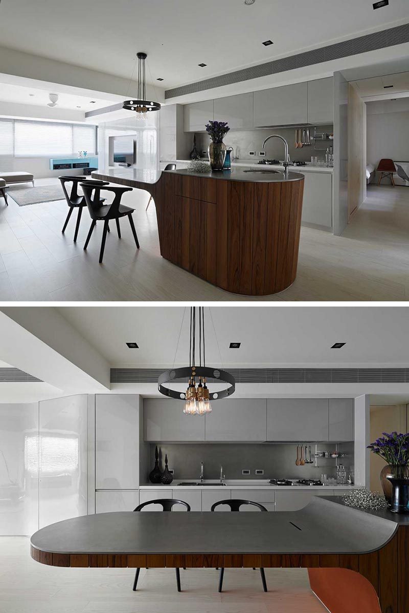 Some homes and small apartments want to have their kitchen island also be the dining table. This can be achieved by having a multi-height kitchen island or a hanging kitchen island, where there's open space underneath to accommodate armchairs. #KitchenIsland #KitchenIslandIdeas #KitchenIslandSeating