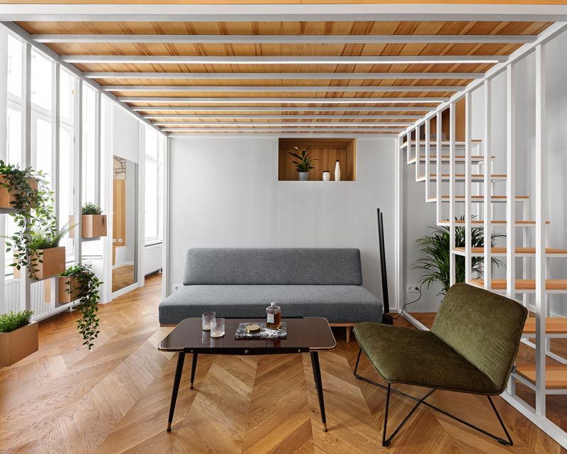 Architres Studio has designed the interior of a modern apartment in Budapest, Hungary, that has high ceilings and wood floors throughout. #ApartmentDesign #ApartmentInterior #ModernApartment