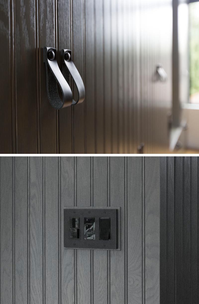 Black hardware such as leather pulls and light switches have been used so that they somewhat blend in with the dark grey finish of the closets. #BlackLeatherPulls #DarkGreyCabinets