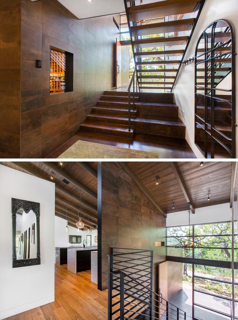 This modern house has stairs with a black steel handrail that connects the levels of the house. #ModernStairs #StairDesign