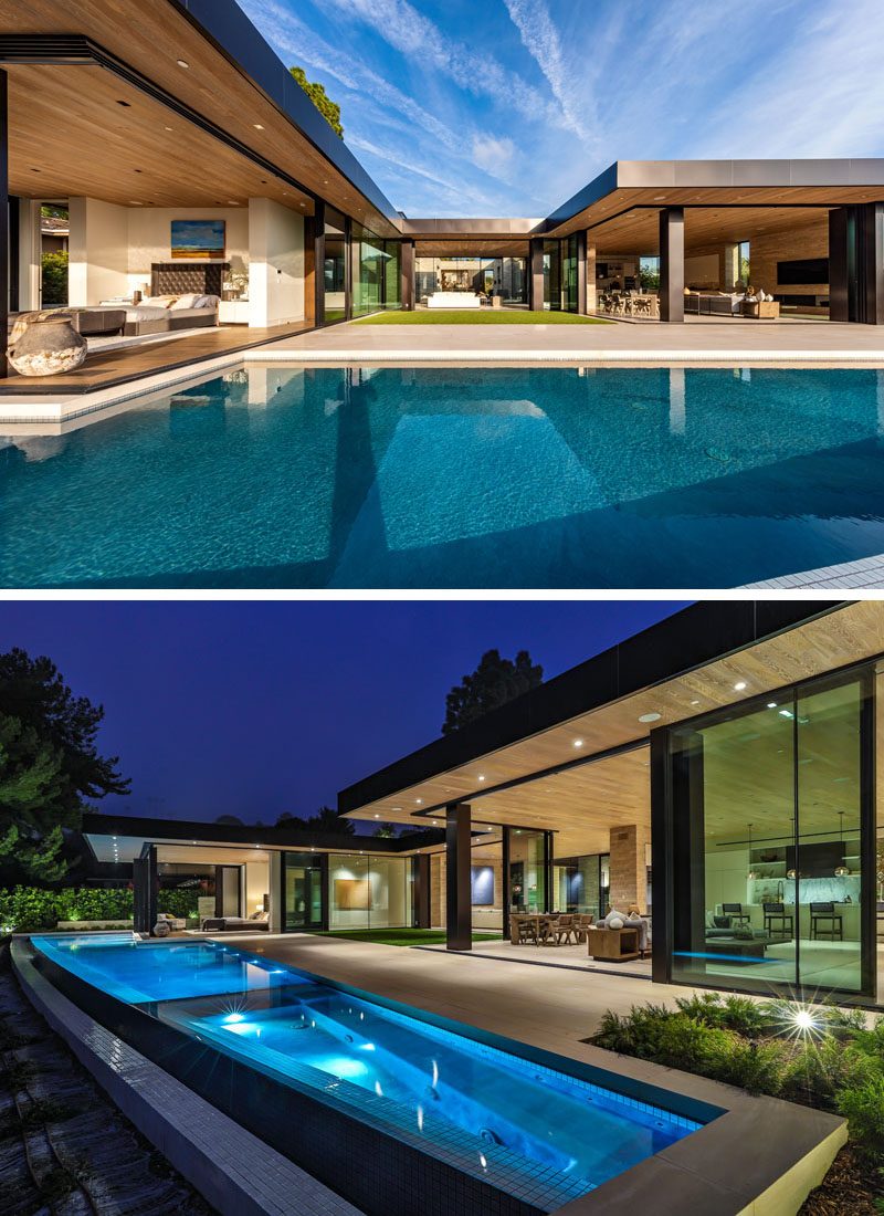 The walls of the social areas of this modern house also open up to the patio and swimming pool, which at night has lights to highlight it. #ModernHouse #SwimmingPool