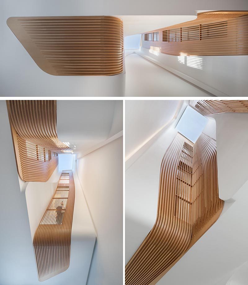 Wood slat details draw the eye upward to a single skylight that fills this home with natural light. #Skylight #WoodAccents #InteriorDesign