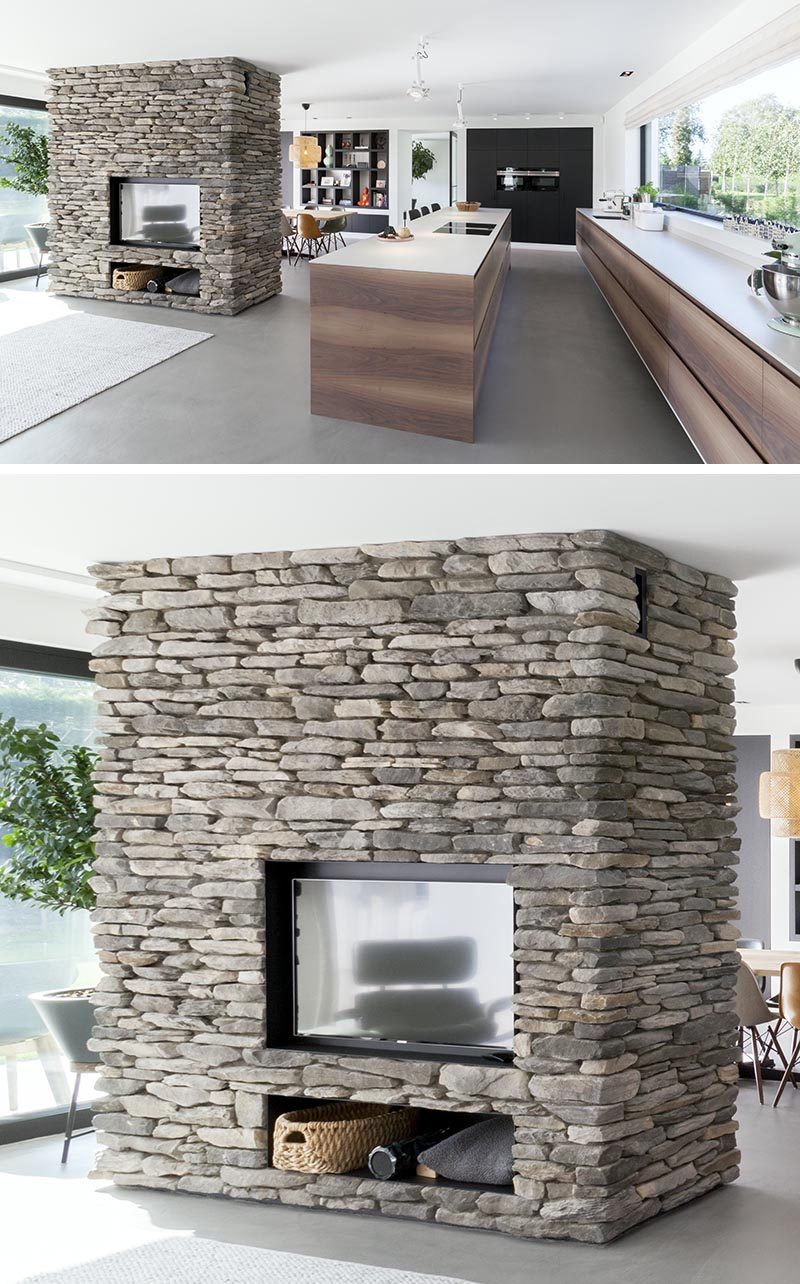 Apart from separating the dining area and living room, this stone accent partition is home to a linear fireplace on the dining room side, and on the opposite side, a built-in television with storage below. #StonePartition #StoneFireplaceSurround #StoneWall