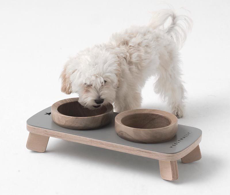 This modern pet food and water bowl stand, has walnut bowls that rest within a platform. #PetFurniture #ModernPetFurniture
