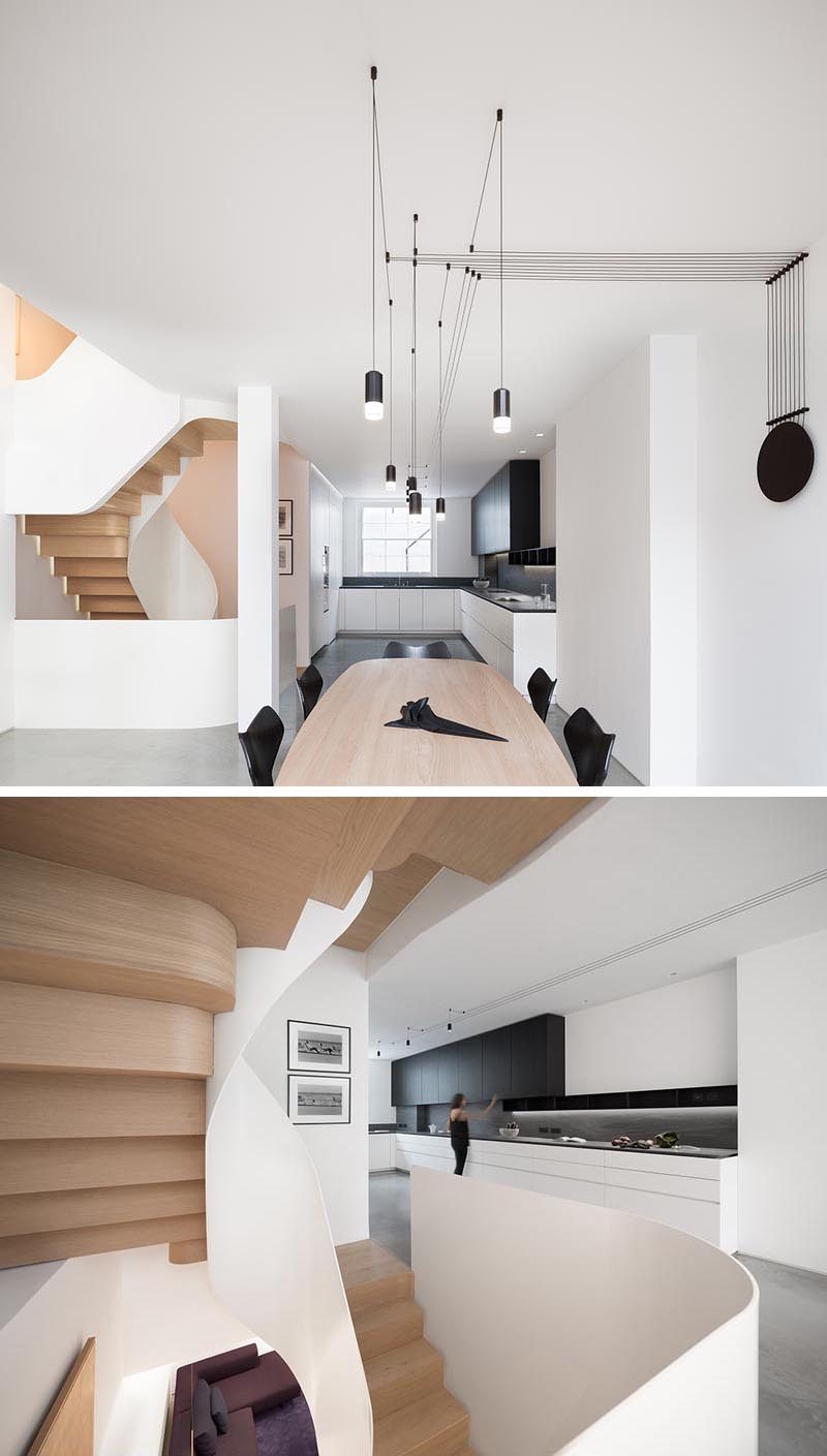 In this modern kitchen, dark upper cabinets, backsplash, shelving and countertop contrast the white cabinets and walls. #ModernKitchen #KitchenDesign