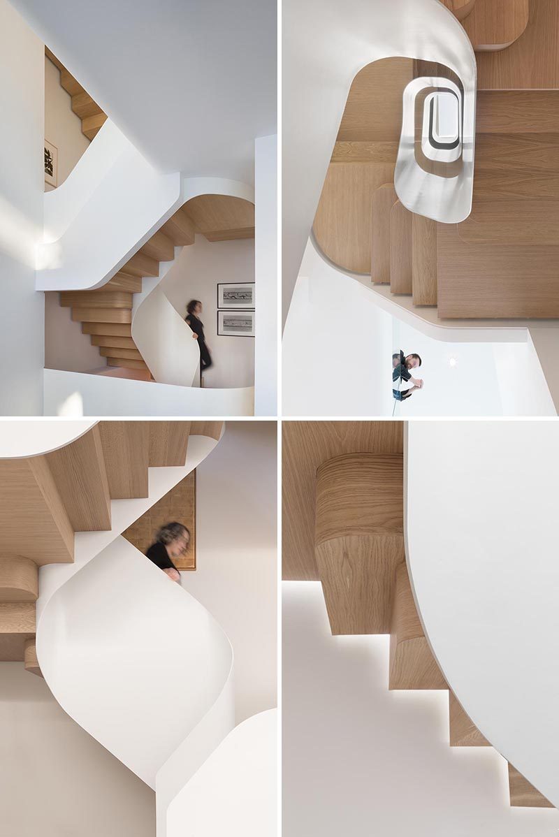 Wood stairs spiral their way between the floors of this house, adding a sculptural element to the home. #WoodStairs #ModernStairs #SpiralStairs