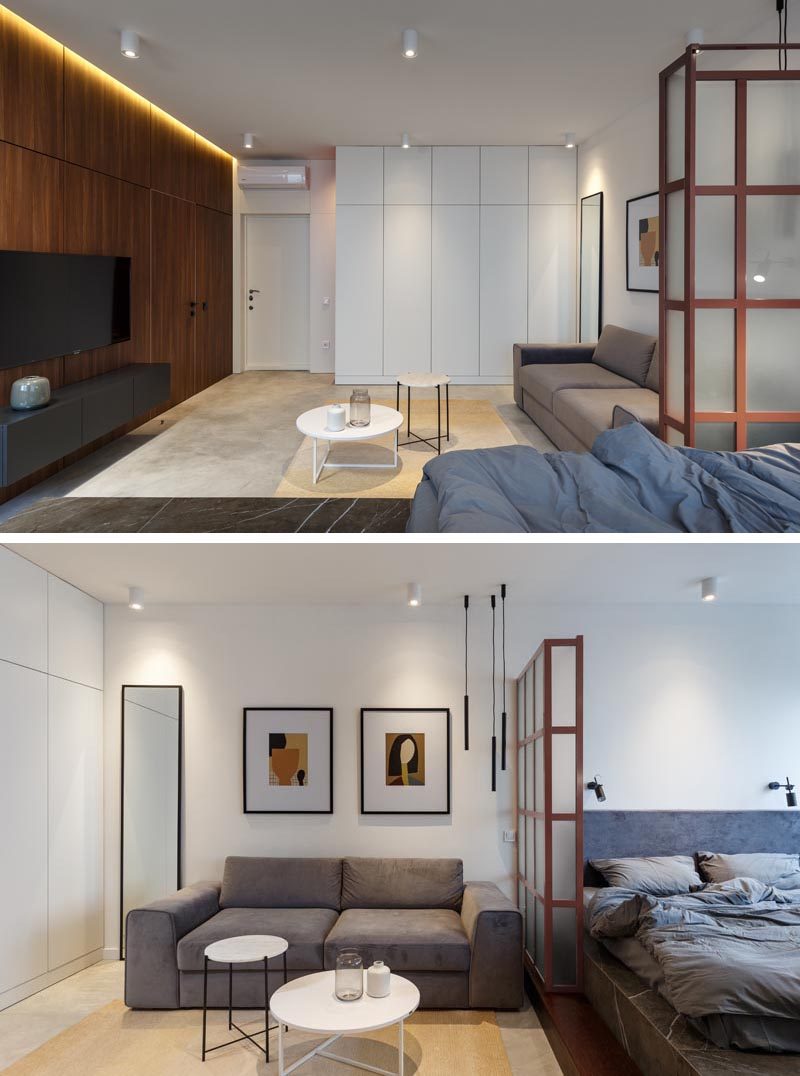 Stepping inside this small apartment, you are greeted by the living area and a large wood accent wall with hidden lighting and a smaller white wall with plenty of storage.