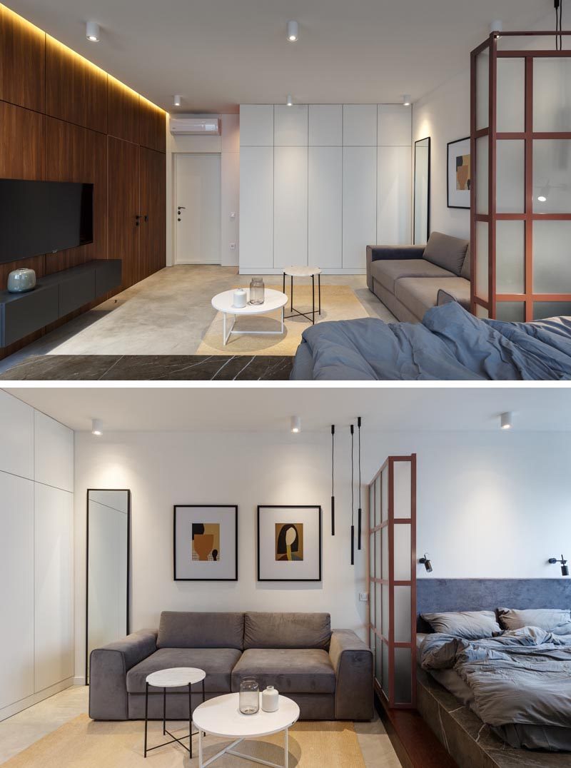 Stepping inside this small apartment, you are greeted by the living area and a large wood accent wall with hidden lighting and a smaller white wall with plenty of storage.