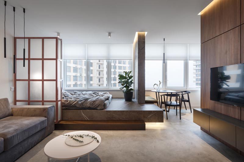 SVOYA studio has recently completed the modern interior of a small 400 square foot (39m2) apartment, that features a bed raised on a platform. #SmallApartment #PlatformBed #InteriorDesign #OpenBedroom