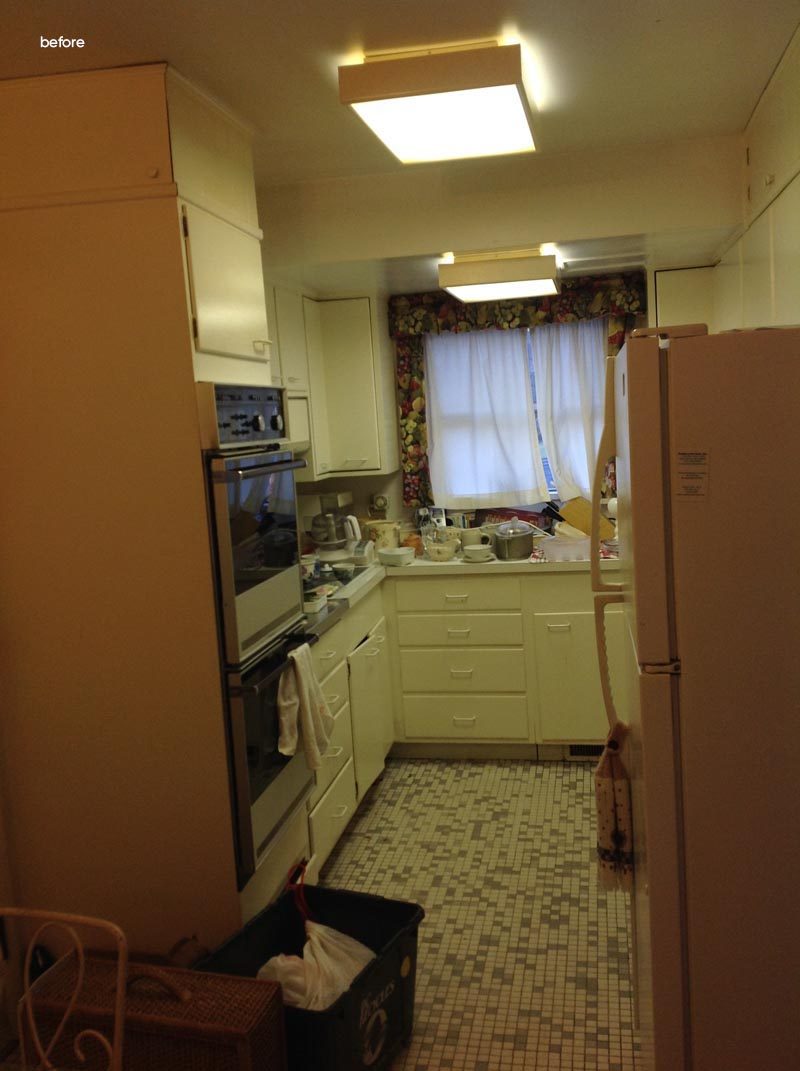 Before Photo - This dated original kitchen was small, with cream colored cabinets and multicolored tile flooring. #Kitchen