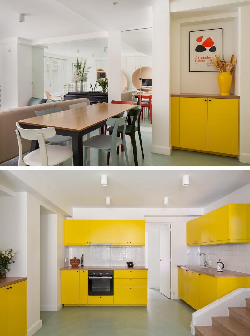 Throughout this modern apartment, bold colors were introduced to compensate for the lack of light in the apartment, like the bright yellow that's been used in the dining area and the kitchen. #YellowKitchenCabinets #YellowCabinetry