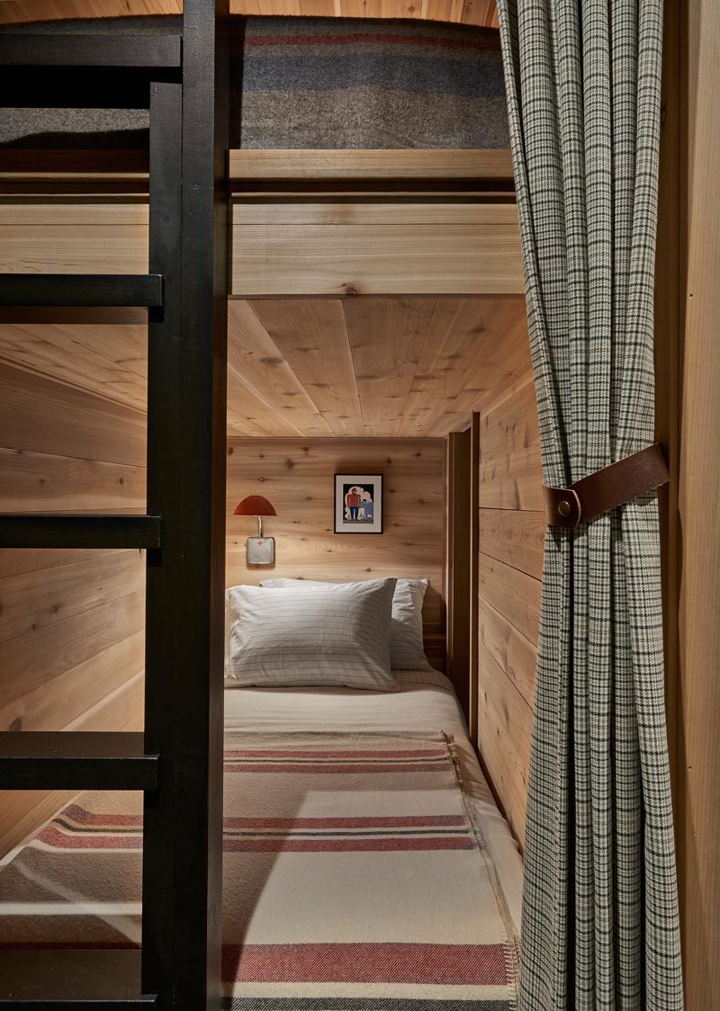 This modern house also has a room that houses two pairs of bunk beds. Curtains provide privacy, while black ladders allows for ease of access., and lamps create a source of light. #BunkBeds #Bunks