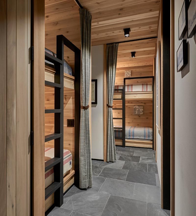 This modern house also has a room that houses two pairs of bunk beds. Curtains provide privacy, while black ladders allows for ease of access., and lamps create a source of light. #BunkBeds #Bunks