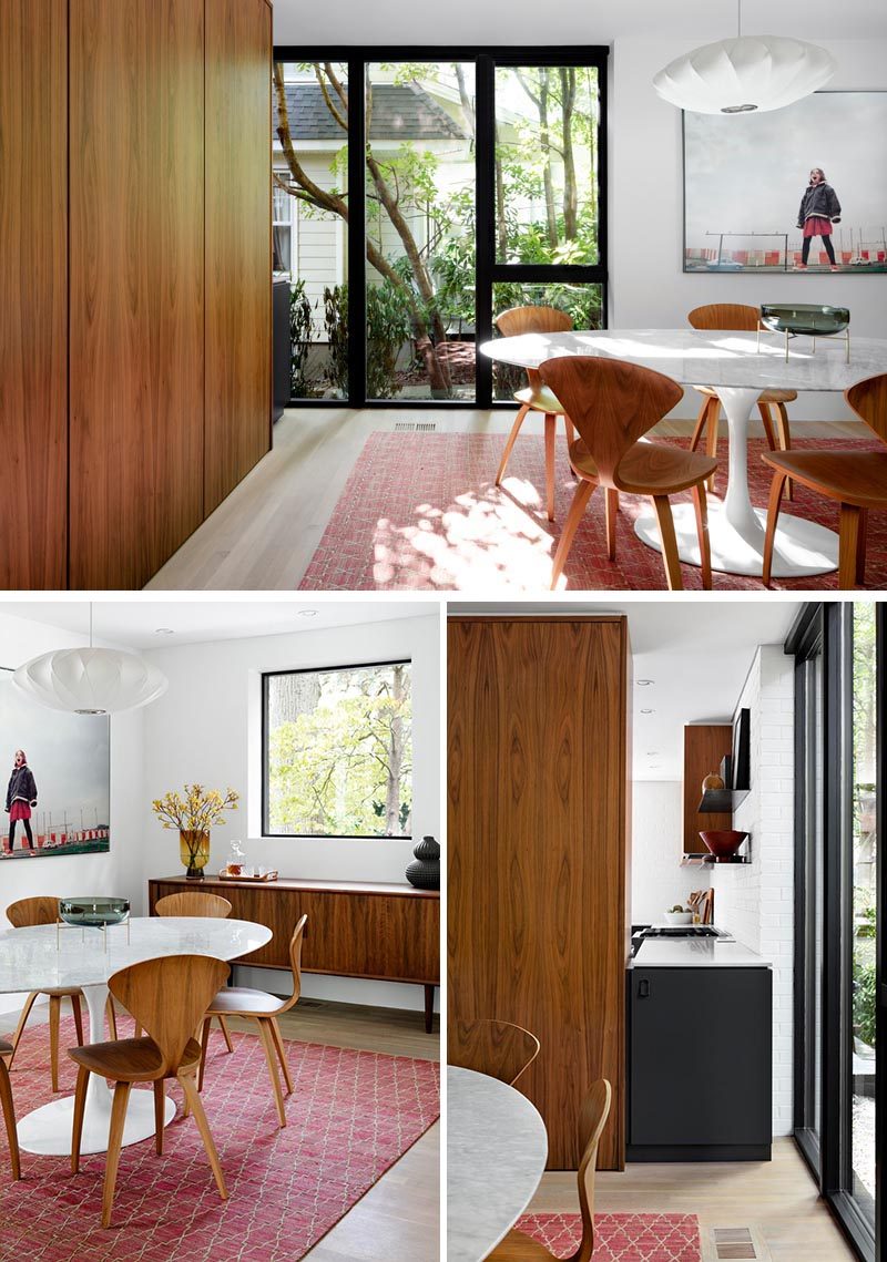 In this modern dining room, a large rug and a single pendant light dictate the location of the table, while artwork adds a fun touch and complements the colors in the rug. #ModernDiningRoom #DiningRoom