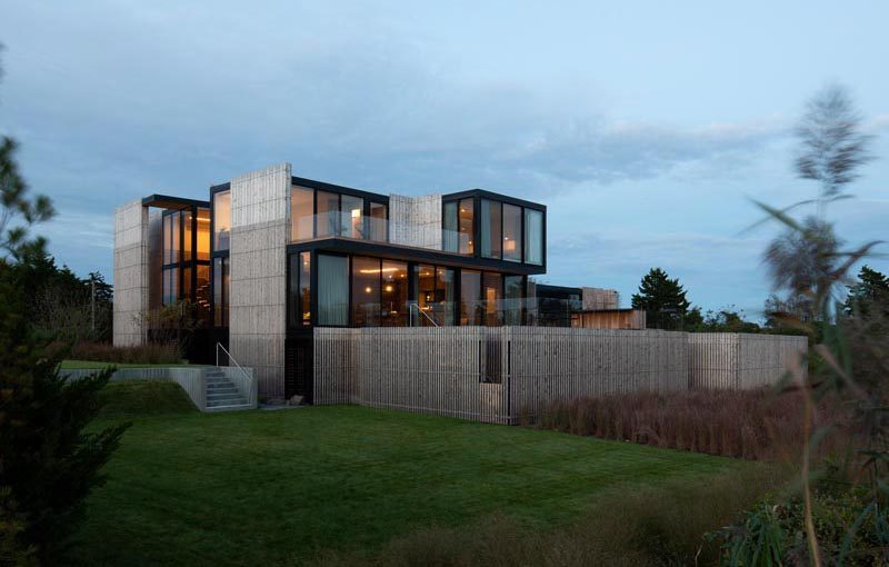 Bates Masi + Architects has completed a new and modern house in Sagaponack, New York, that has an elevated design due to the it being located on a flood-prone site. #ModernHouse #ModernArchitecture #HouseDesign #WoodFacade