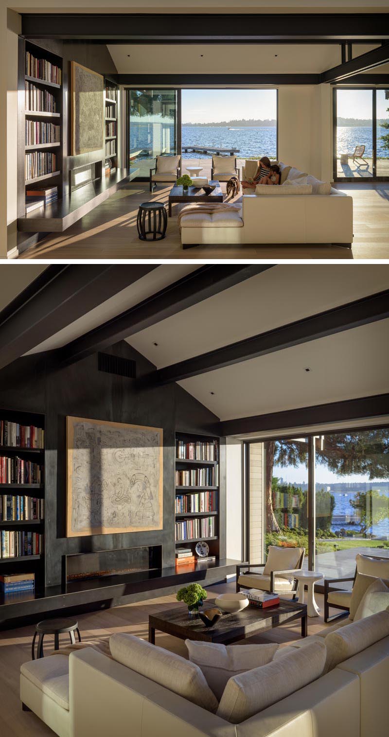 In this living room, a warm yet minimalist palette of white walls, light wood floors, and a contrasting steel fireplace and bookcase creates a clean backdrop for the owners’ modern furnishings and art collection. #ModernLivingRoom #SteelFireplace #Bookcase