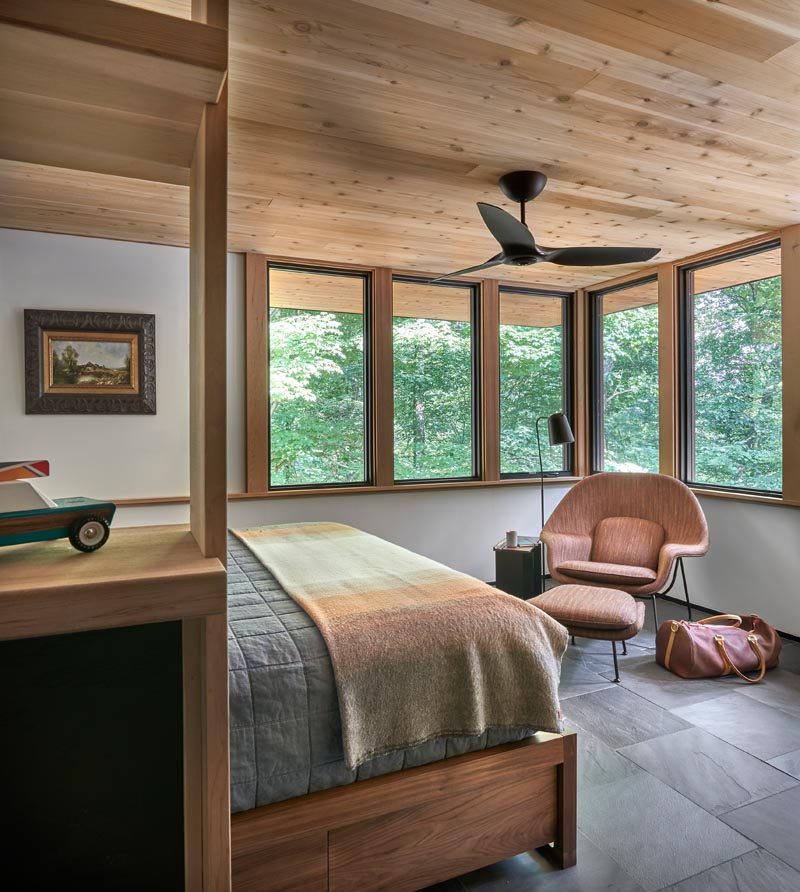 This master bedroom has windows that wrap around the corner and allow natural light to fill the room. #MasterBedroom #BedroomDesign