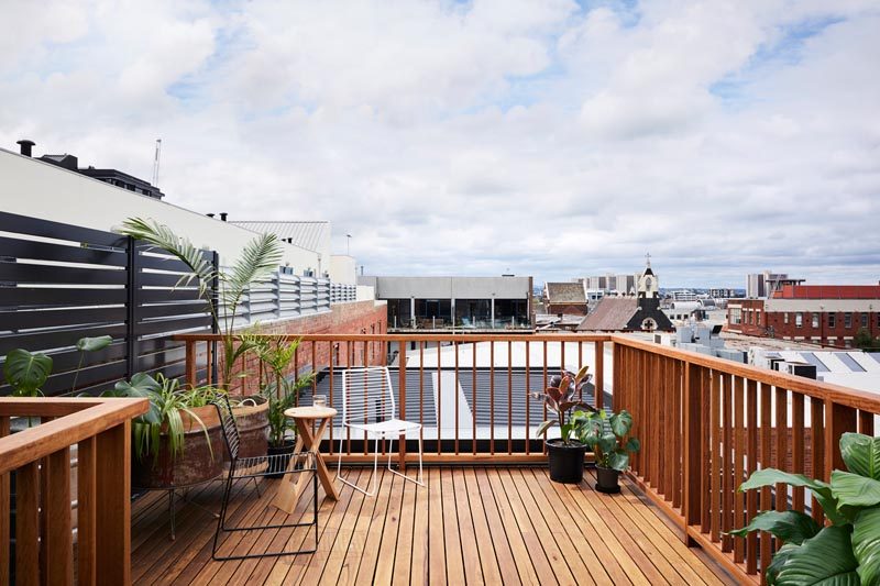 This wooden rooftop deck sits high above the neighborhood, creating an outdoor space where the rooftop views can be enjoyed. #RooftopDeck #Architecture