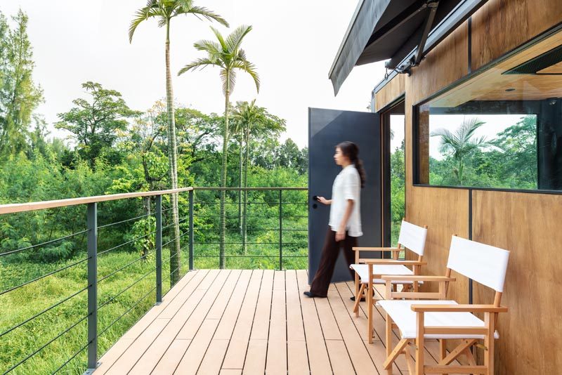 This simple balcony has wood decking and a simple wood and steel railing. #Balcony