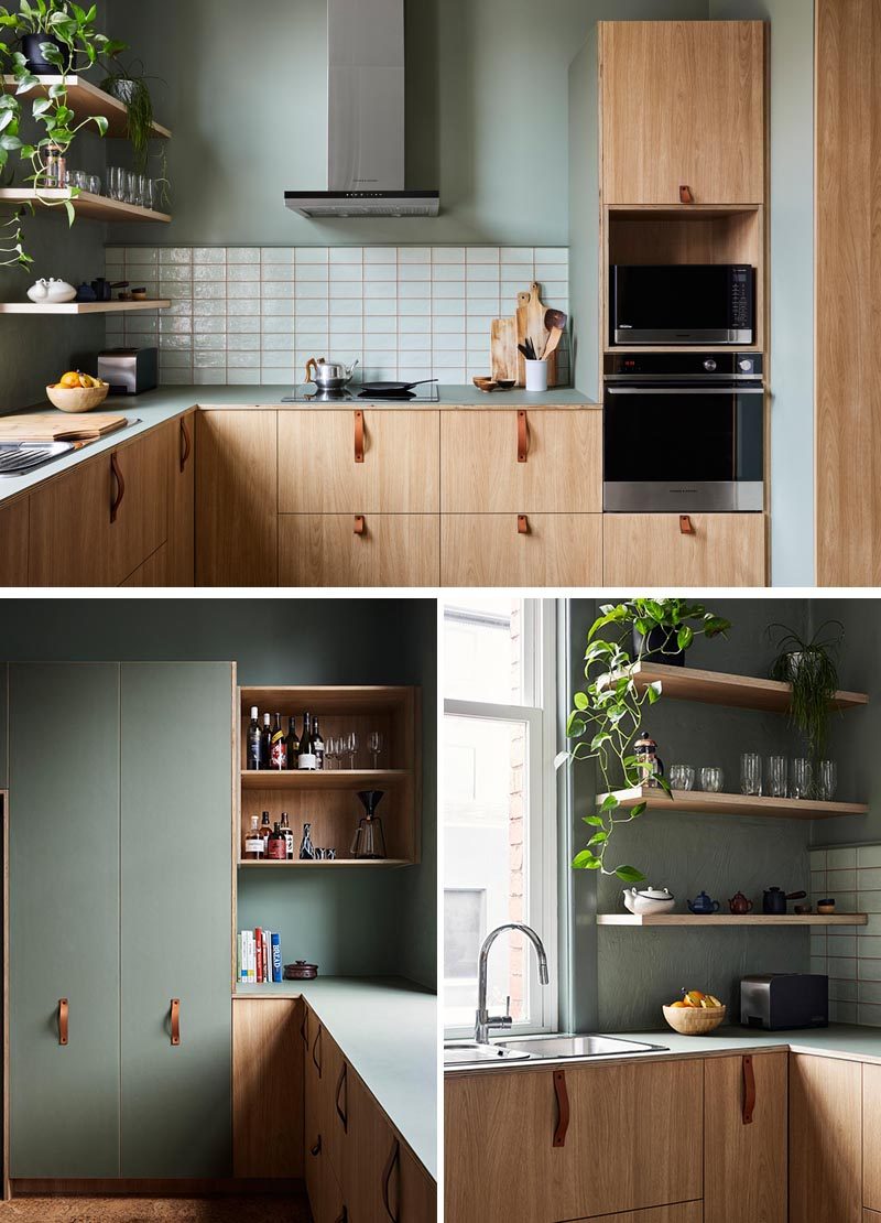 This modern kitchen combines wood cabinets with leather handles, and sage green walls with a white backsplash. #ModernKitchen #GreenWalls #WoodCabinets