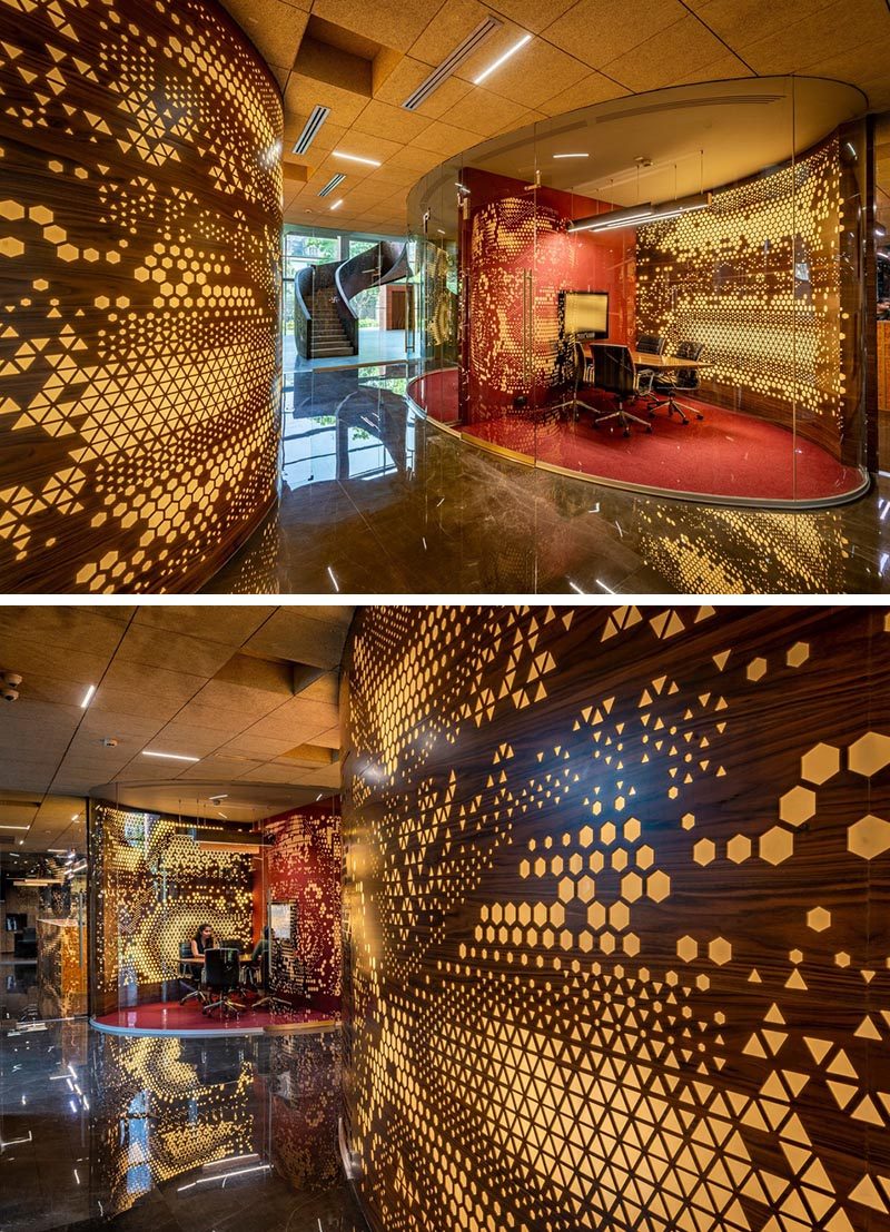 The random assortment of patterns and shapes in these curved walls are highlighted by the use of integrated lighting that's hidden behind Plexiglass. #PerforatedWalls #Patterns #WorkplaceDesign #OfficeDesign #Lighting