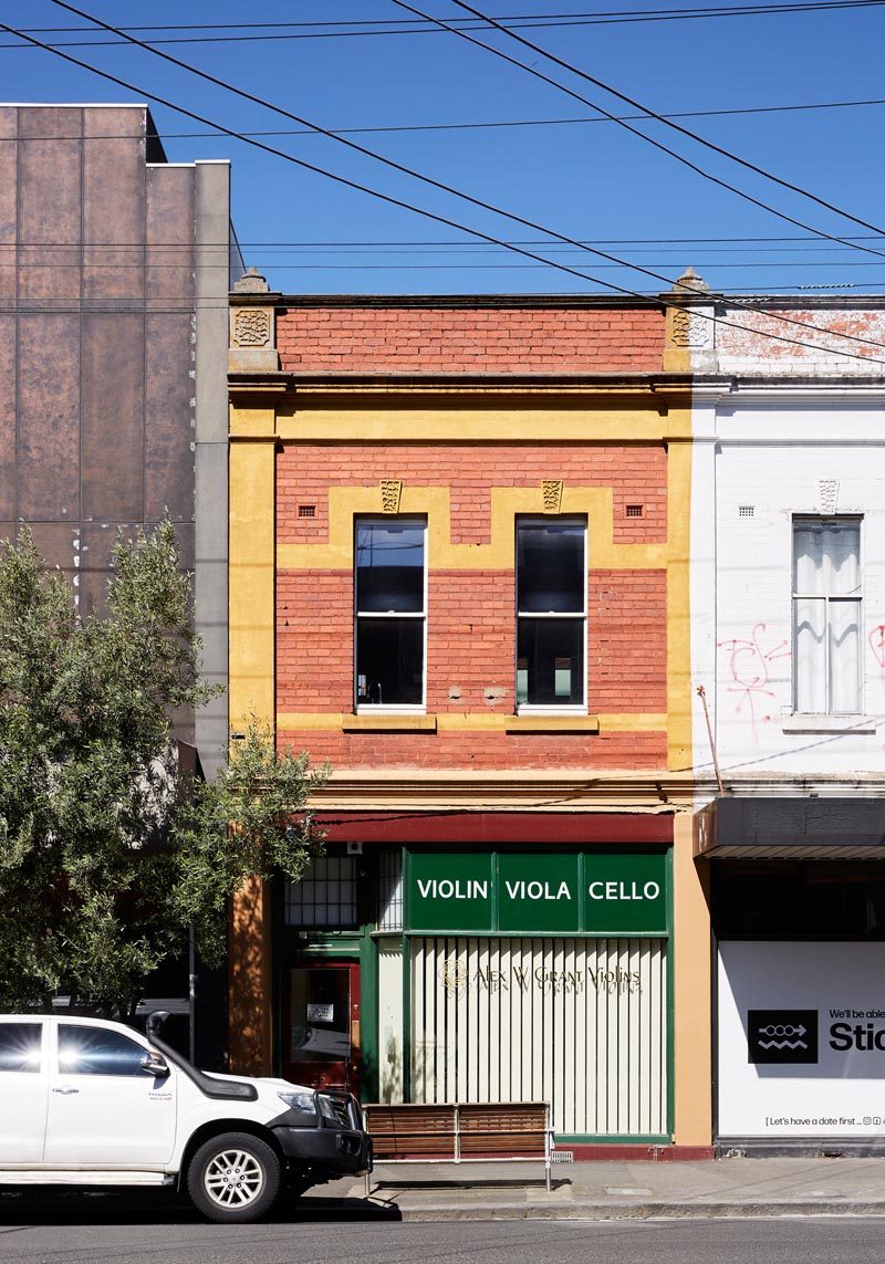 Tsai Design have completed the renovation of a rundown kitchen, living room, and bedroom that's located above their client's specialist violin sellers and repairers shop in Melbourne, Australia. #BrickFacade