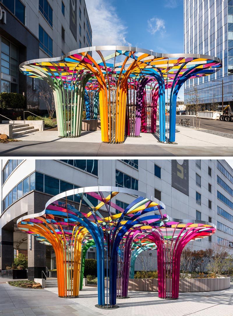 This modern public art installation invites visitors to walk through a grove of archways that have been woven together from intersecting bands of powder-coated aluminum in 28 colors. #PublicArt #PublicInstallation #PublicSculpture #ModernArt #ModernSculpture #Design