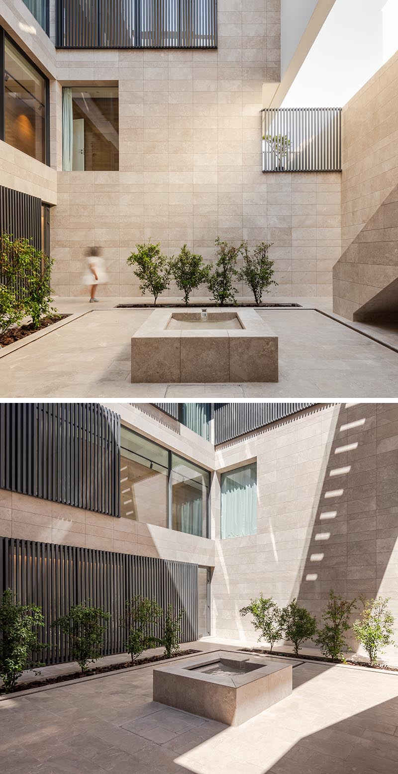 This internal courtyard has lines of plants, a water fountain, and hidden lighting that creates a soft glow at night. #InternalCourtyard #CourtyardLighting #OutdoorSpace