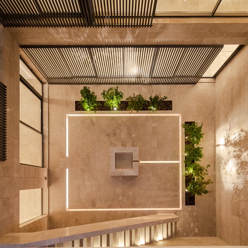 This internal courtyard has been designed with lighting embedded into the stone tiles, creating a soft glow that can be enjoyed at night. #OutdoorLighting #CourtyardLighting #EmbeddedLighting