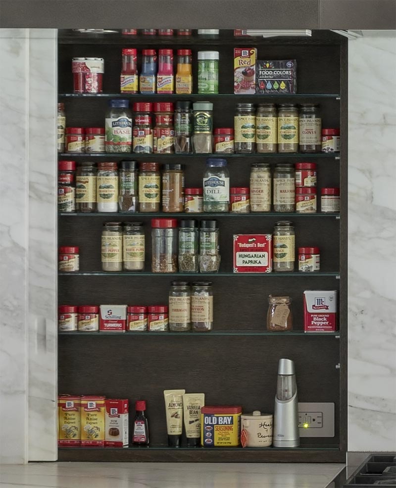 Kitchen Design Idea - Spice racks and shelves are often overlooked, however in this kitchen there are two sliding panels neatly disguised on either side of the stove, adding storage and keeping the spices within reach. #SpiceRack #SpiceShelf #HiddenSpiceRack #HiddenStorage #KitchenDesign