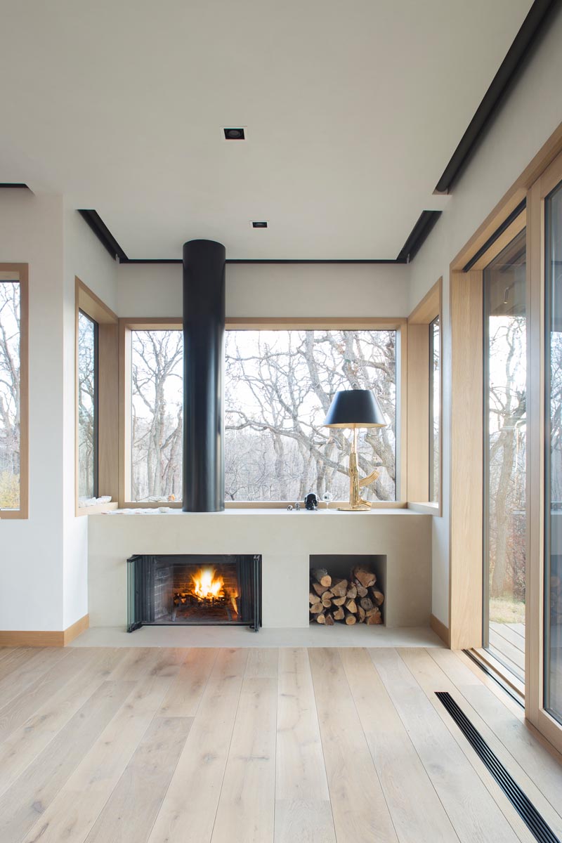 This modern master suite has a fireplace and blackout blinds that are recessed into the ceiling. #BlackoutBlinds #Fireplace