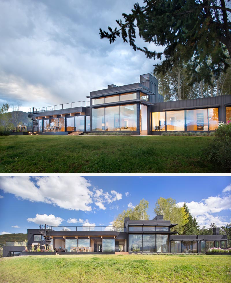 The entire length of this modern house has been designed with an abundance of windows. Spiral stairs at one end lead up to a rooftop deck. #ModernHouse #HouseDesign #ModernArchitecture