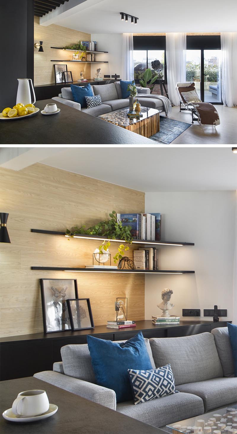 In this modern living room, the corner has been adorned with a pair of shelves that keeps the corner bright and highlights the displayed items. #CornerShelves #CornerShelf #Lighting #ModernLivingRoom