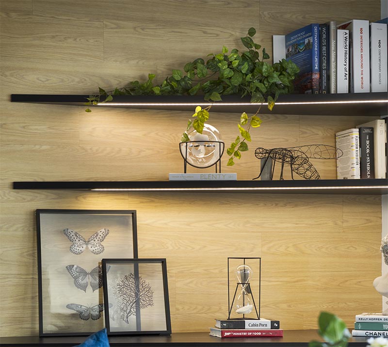 In this modern living room, the corner has been adorned with a pair of shelves that keeps the corner bright and highlights the displayed items. #CornerShelves #CornerShelf #Lighting #ModernLivingRoom