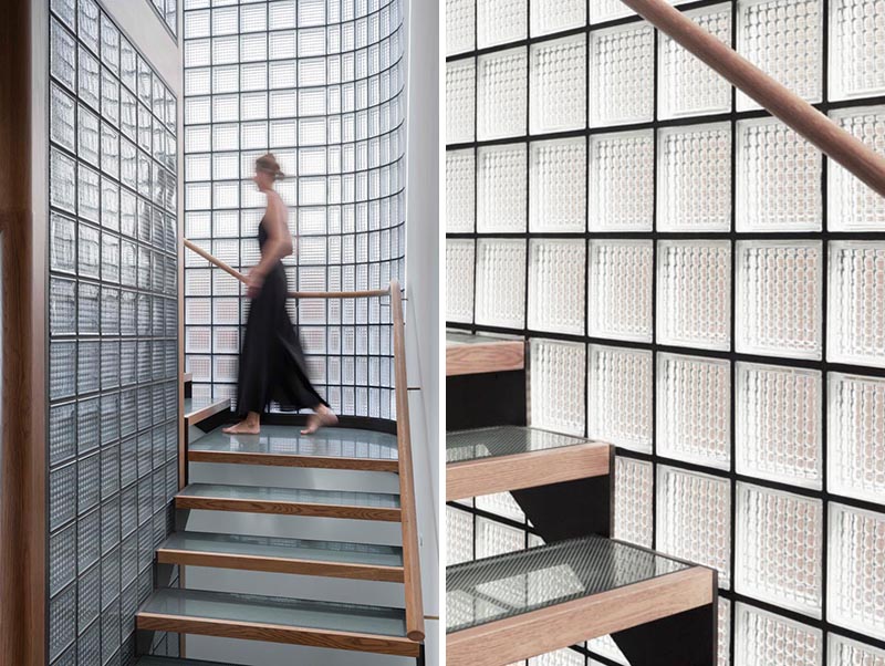 This modern house features a stairwell surrounded by glass blocks with black grout, and steel, wood, and glass treads. #ModernGlassBlock #GlassBlock #Stairs #Stairwell