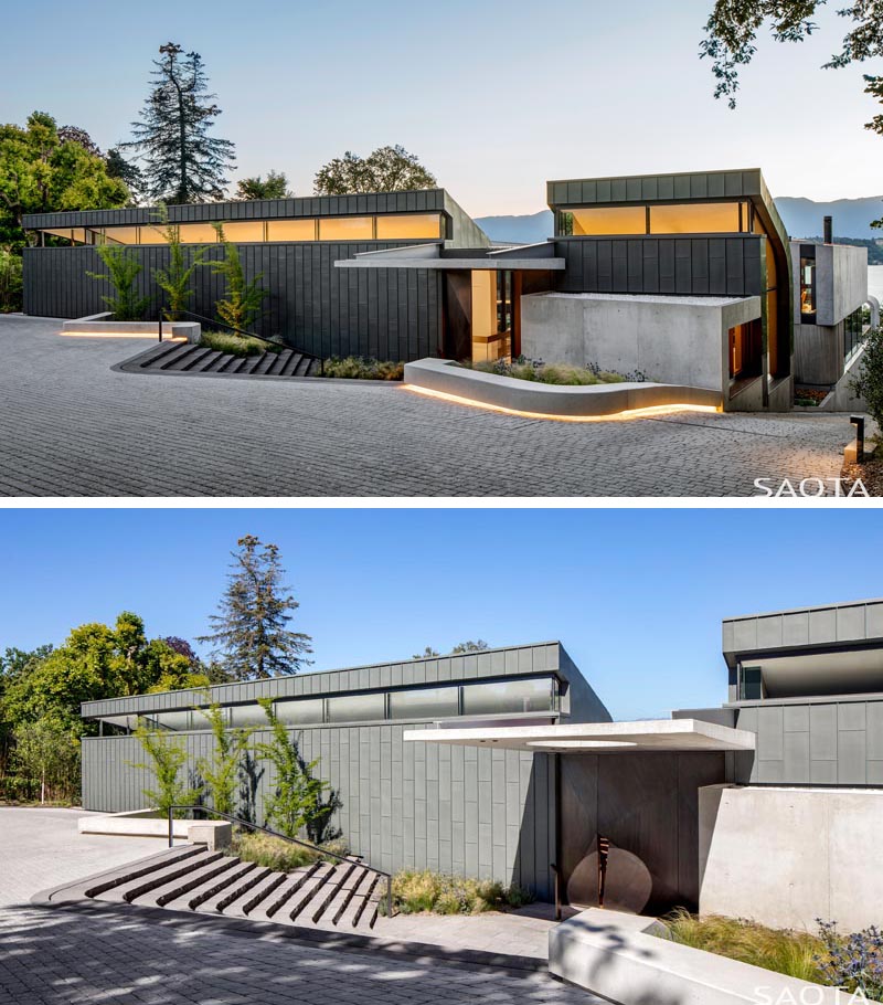 The exterior of this modern house features Zinc cladding, while lighting at night shows off the lines of the house, and guide visitors to the front door. #ZincCladding #ModernHouse #ModernArchitecture