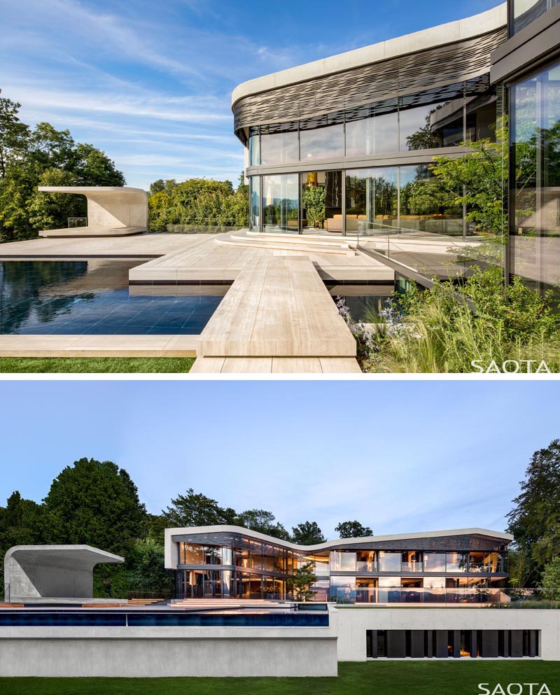 Walls of glass open this modern house to an expansive outdoor space with a curved concrete cabana sitting next to the swimming pool. From this angle, you are able to see the laser-cut aluminium shading screen that follows the curves of the roof. #Architecture #PoolCabana #SwimmingPool #ShadeScreen #ModernHouse