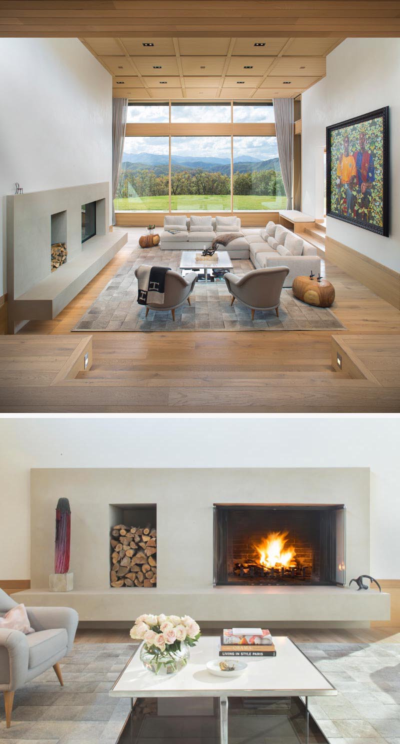 This modern living room is stepped down slightly from the entryway and kitchen. Large windows immediately provide uninterrupted views of the mountain landscape, while the furniture is focused on the wood-burning fireplace. #LivingRoom #SunkenLivingRoom #Fireplace #Windows