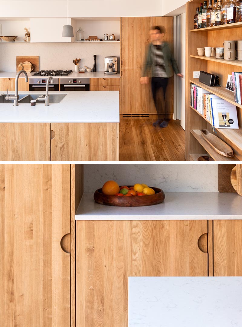 Kitchen Ideas - To stay within their budget, the designers created a kitchen using standard off-the-shelf kitchen units, but they had bespoke natural oak fronts and facing dividers made that included small cut-out finger pulls instead of hardware. #ModernWoodKitchen #HardwareFreeKitchen #KitchenDesign #OakCabinets