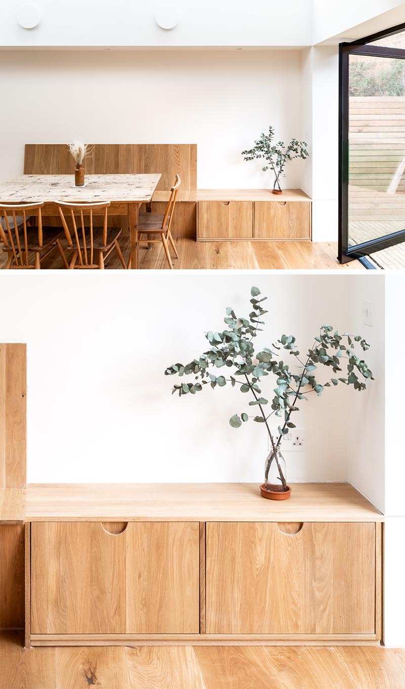 Kitchen Ideas - To stay within their budget, the designers created a kitchen using standard off-the-shelf kitchen units, but they had bespoke natural oak fronts and facing dividers made that included small cut-out finger pulls instead of hardware. #ModernWoodKitchen #HardwareFreeKitchen #KitchenDesign #OakCabinets